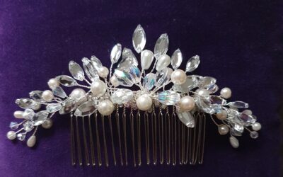 A lovely bridal hair comb featuring pearls, diamante leaves, aurora borealis beads, and crystal stones